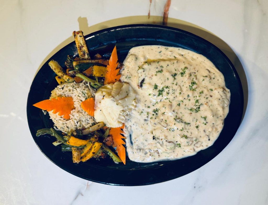 Creamy white sauce steak with grilled chicken at Caffeine Tales
