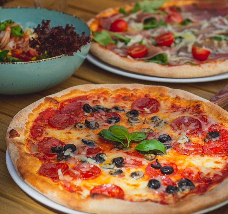 Freshly baked Margherita pizza with vegetables and cheese at Caffeine Tales