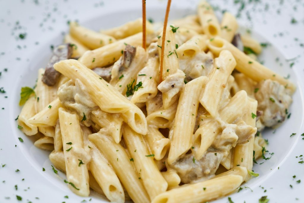 Creamy white sauce pasta with grilled chicken at Caffeine Tales