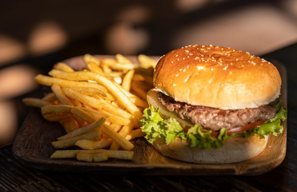 Juicy burger with crispy fries at Caffeine Tales