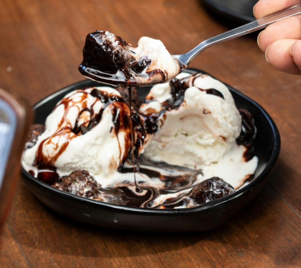 Chocolate dessert topped with vanilla ice cream at Caffeine Tales