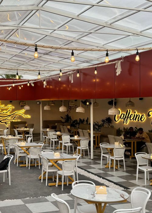 Comfortable seating space with modern decor and natural tones at Caffeine Tales
