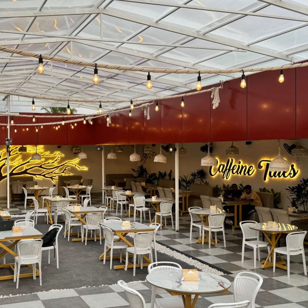 Comfortable seating space with modern decor and natural tones at Caffeine Tales