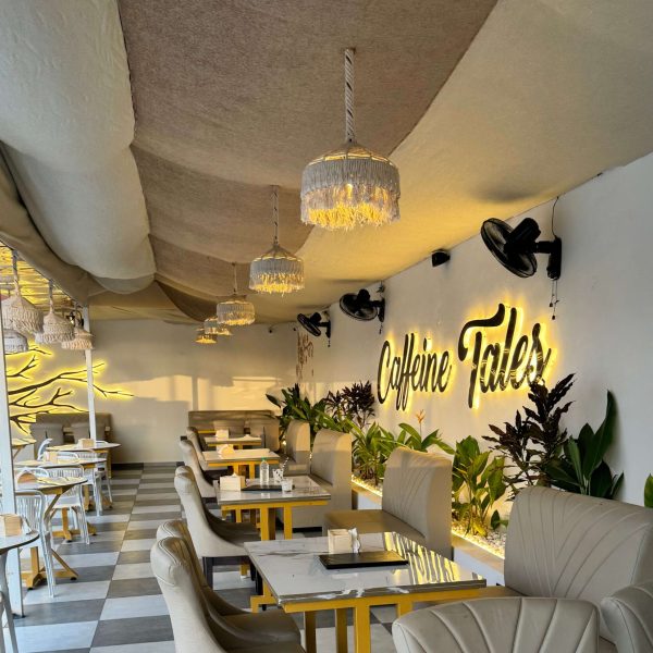 Comfortable seating space with modern decor and natural tones at Caffeine Tales