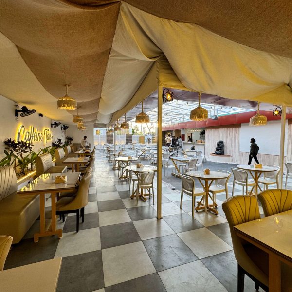 Comfortable seating space with modern decor and natural tones at Caffeine Tales